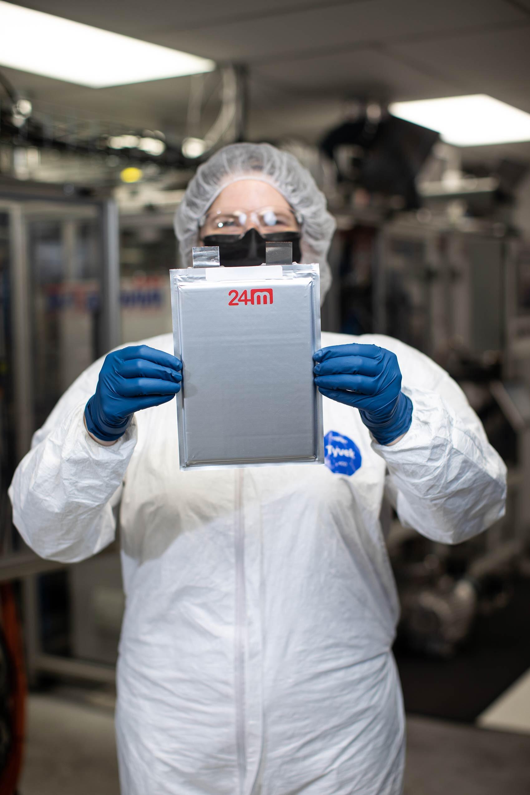 24M lab worker holding a battery cell