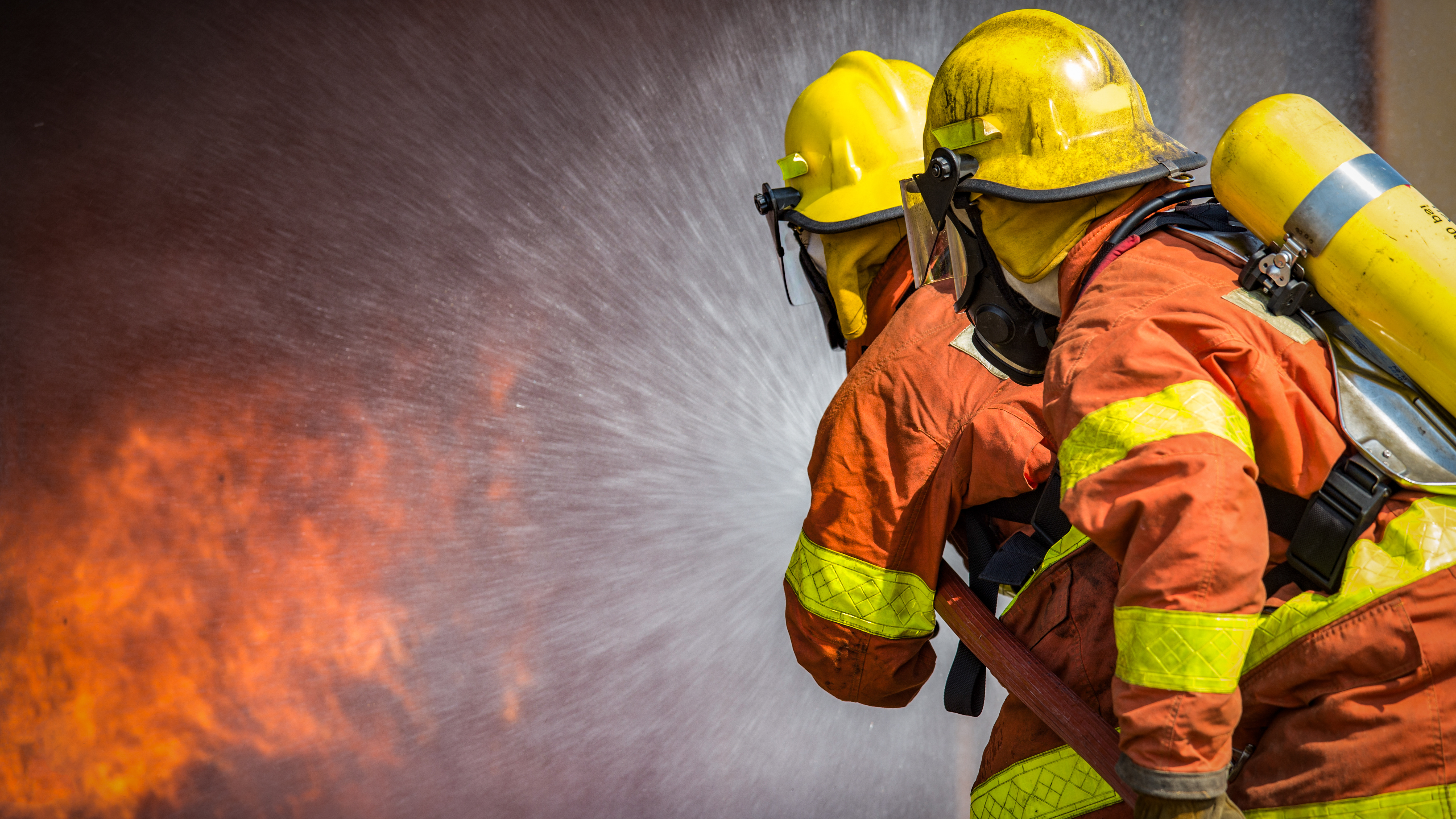 Two firefighters putting out a fire